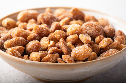 Honey roasted peanuts from Whole Food Earth, showing shiny, caramelized coating on crunchy roasted nuts in a close-up image.