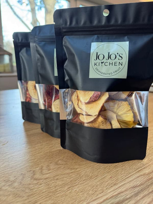 Mixed dehydrated fruit snacks multipack by JoJo’s Kitchen featuring apple, pear, and pineapple slices in a colorful assortment.
