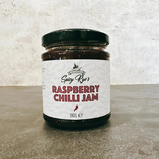 Spicy Ryes Raspberry Chilli Jam jar with vibrant red jam and chili peppers on the label, showcasing the flavorful condiment.