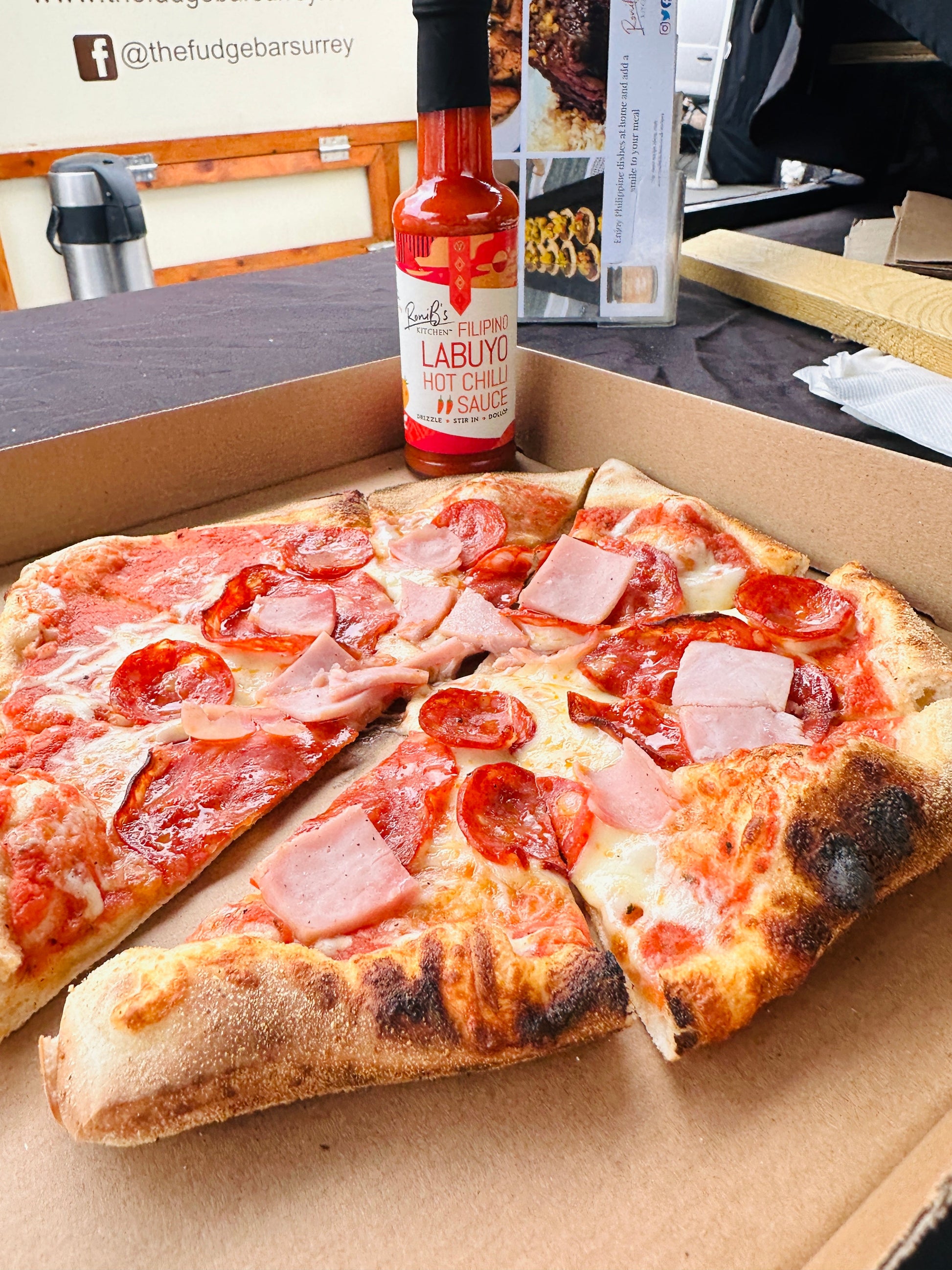 Filipino Style Labuyo Hot Chili Sauce by RoniBs Kitchen, vibrant red hot sauce in a glass bottle with tropical fire branding.