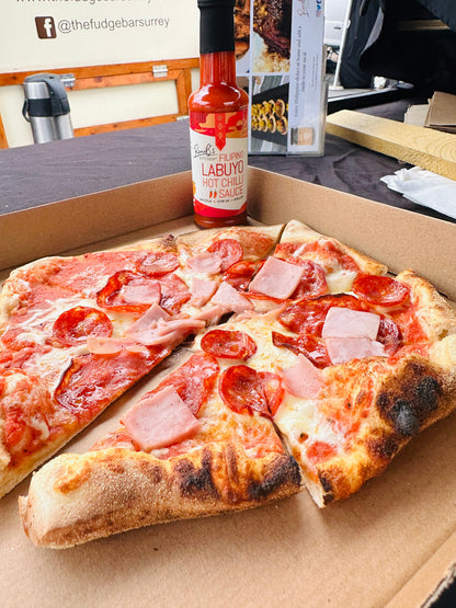 Filipino Style Labuyo Hot Chili Sauce by RoniBs Kitchen, vibrant red hot sauce in a glass bottle with tropical fire branding.