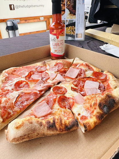 Filipino Style Labuyo Hot Chilli Sauce by RoniBs Kitchen, vibrant red hot sauce in a glass bottle with tropical chili peppers.