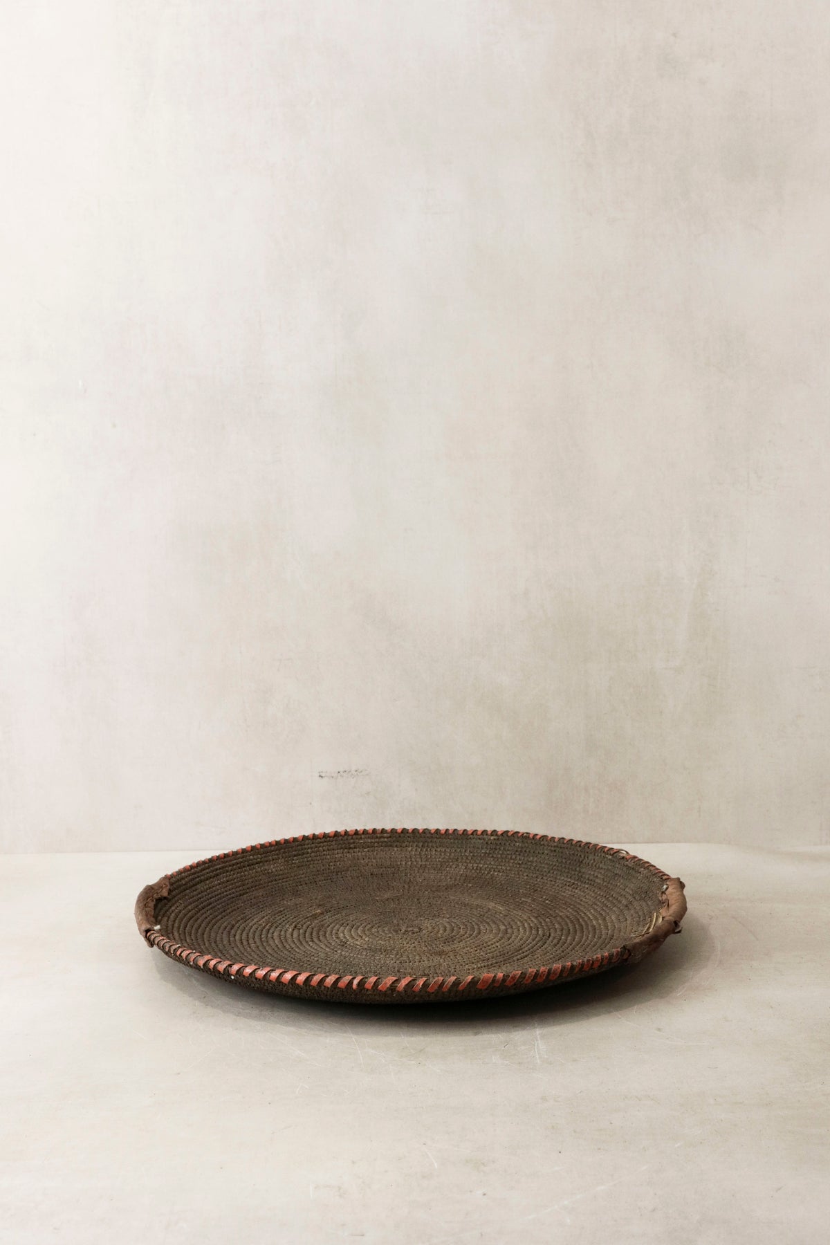 Handwoven wall basket from Chad by Botanical Boys, featuring natural fibers and intricate craftsmanship for wall decor.