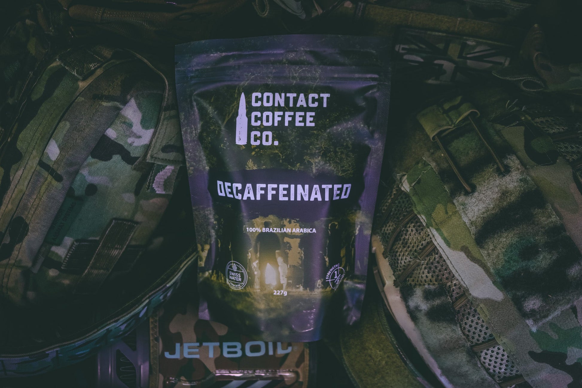 Decaffeinated coffee bag from Contact Coffee Company Ltd., showing the packaging and coffee beans on a wooden surface.