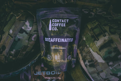 Decaffeinated coffee bag from Contact Coffee Company Ltd., showing the packaging and coffee beans on a wooden surface.