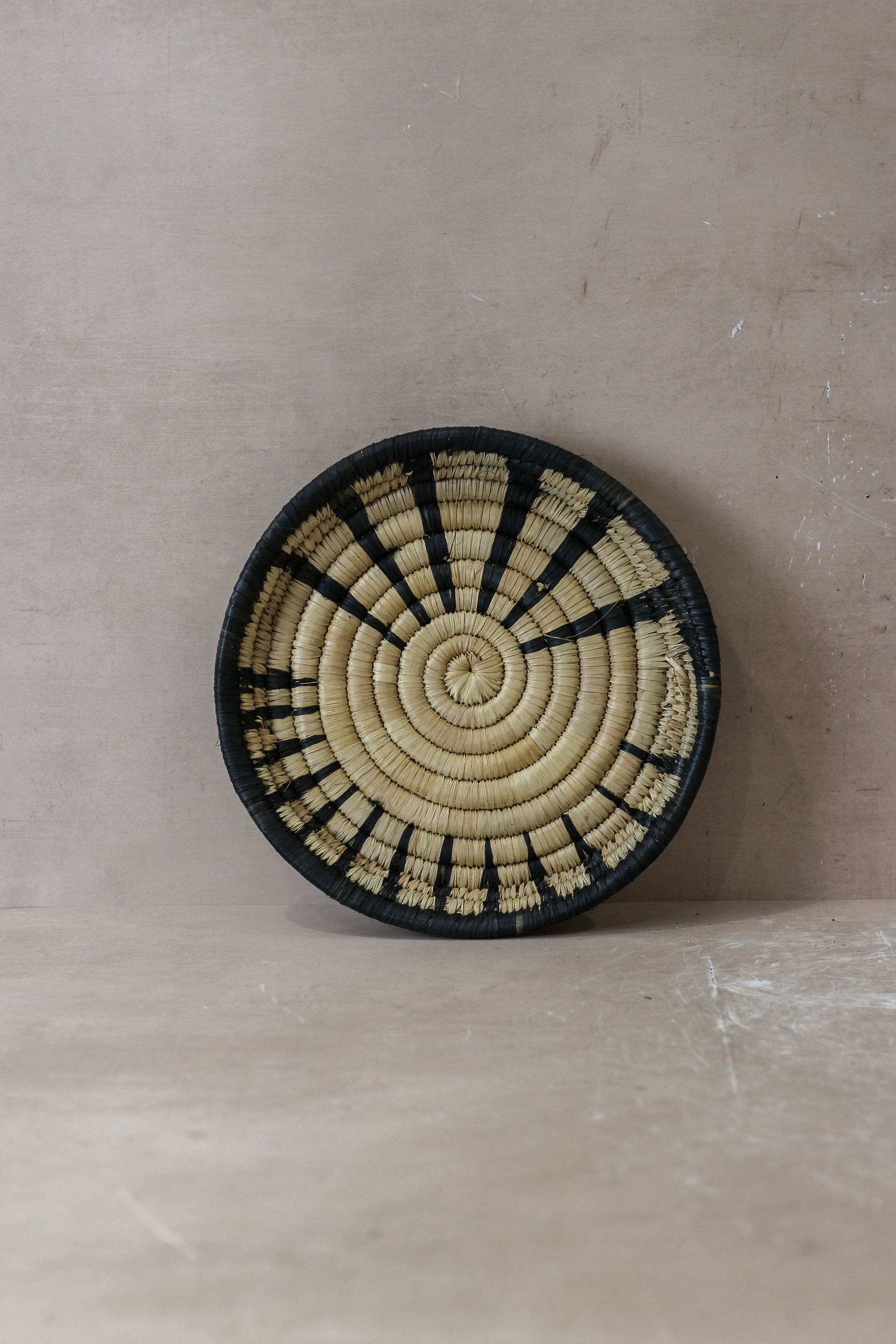 Small Malawi Wall Basket by Botanical Boys, woven basket with natural fibers, ideal for wall decor and storage.