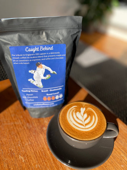 Bag of Caught Behind coffee from Clubhouse Roastery, featuring a rich roast and fresh ground beans in a branded packaging.