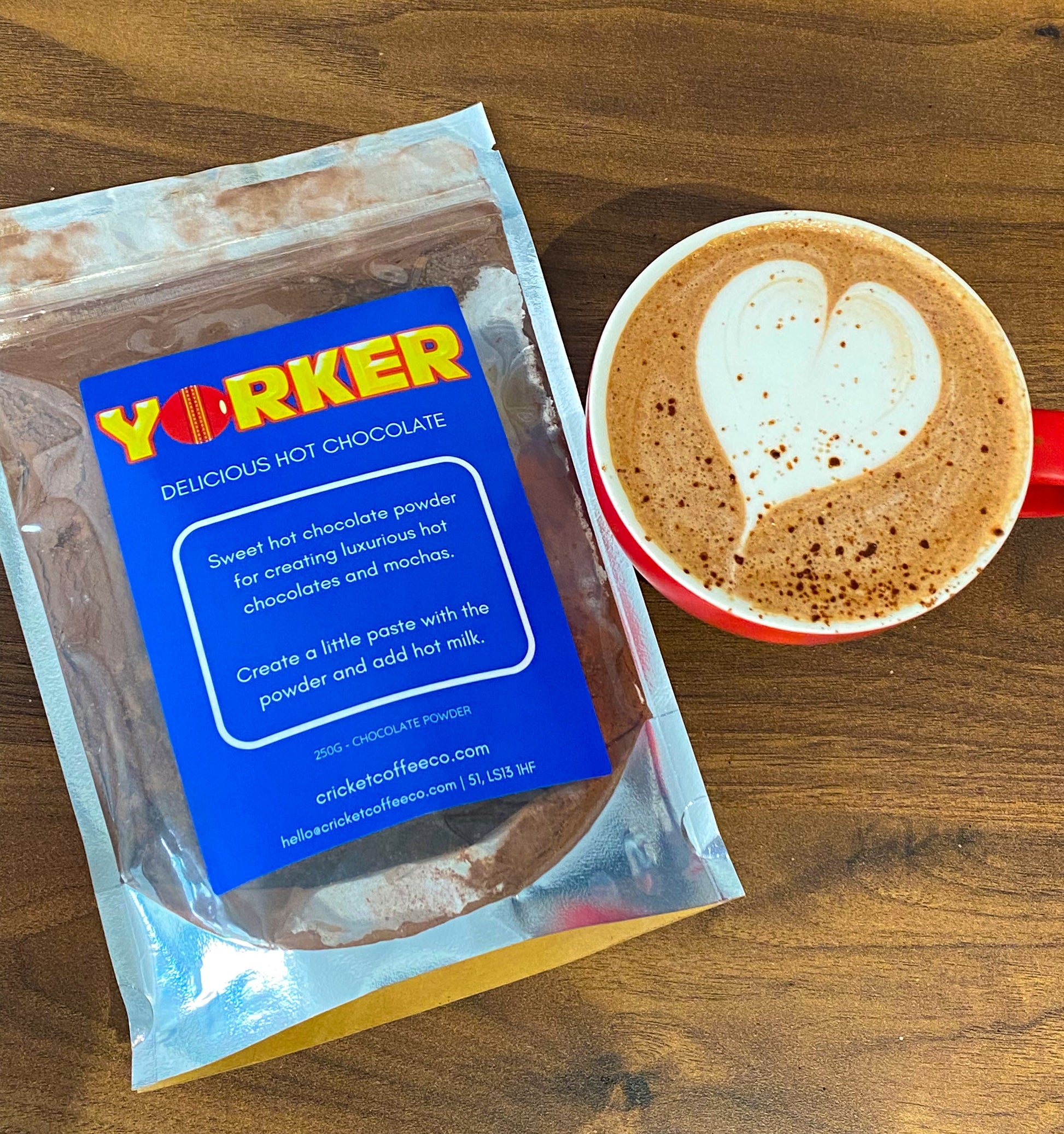 Clubhouse Roastery Yorker Hot Chocolate tea in a clear glass cup with a spoon, showcasing rich, dark tea leaves and steamy presentation.