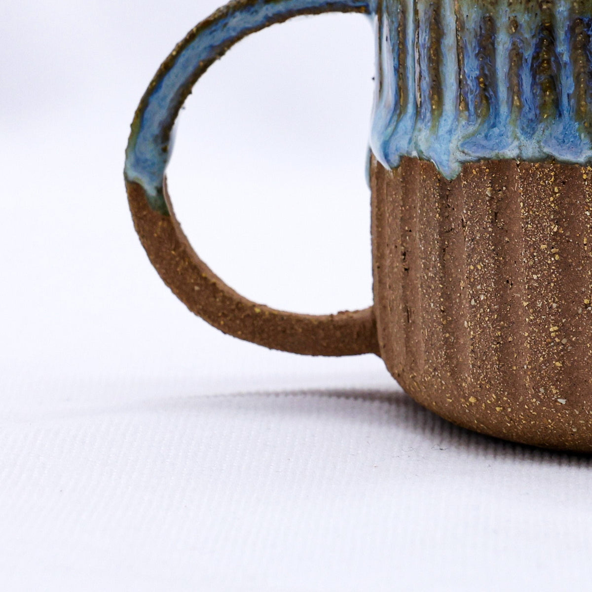 Handmade Terra Stoneware Mug by Ribera Handmade Ceramics with a textured ceramic finish, showcased on a neutral background.