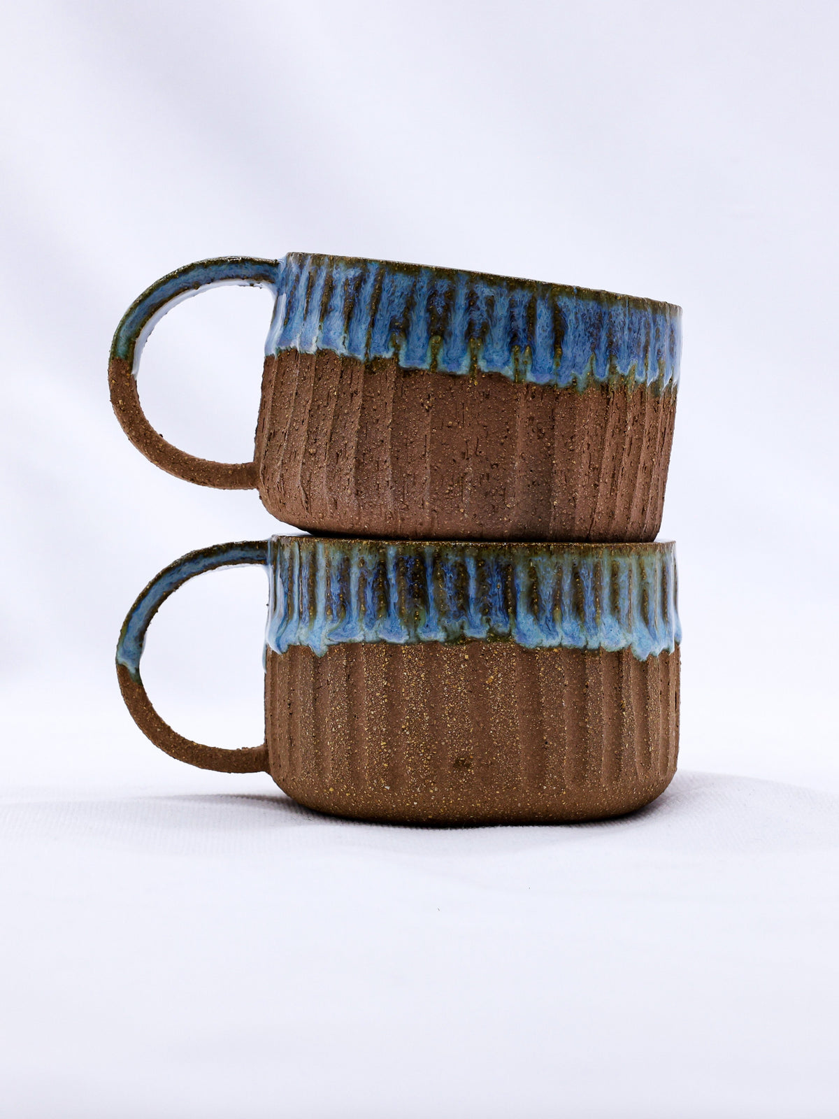 Ribera Handmade Ceramics Bluvio Arte Terra stoneware mug with a handmade ceramic finish and earthy tones.