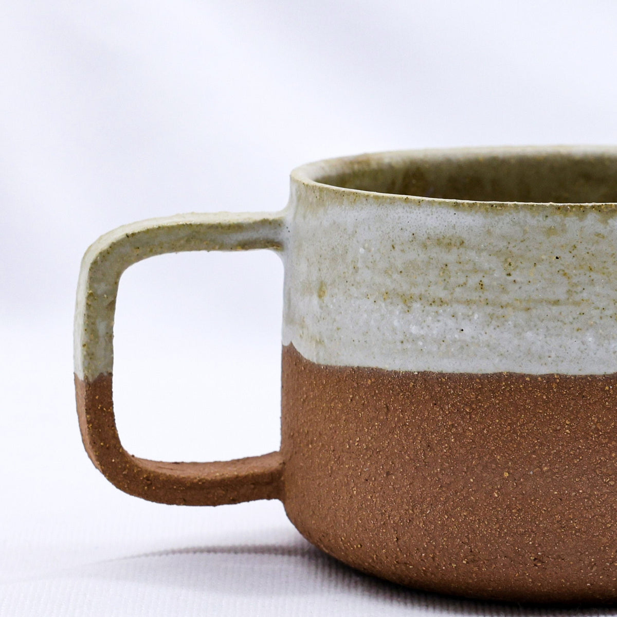 Bianca Grande handmade ceramic terra stoneware mug by Ribera Handmade Ceramics, featuring earthy tones and a textured surface.