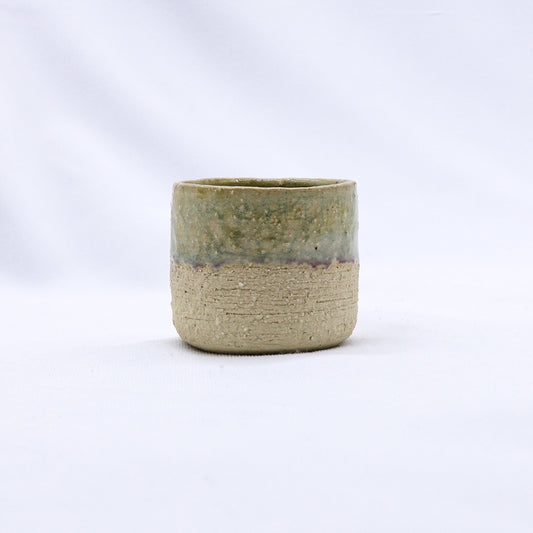 Beige Picollo handmade ceramic espresso mug with milled stoneware finish by Ribera Handmade Ceramics, showing its textured surface.