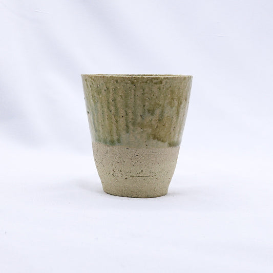 Beige Quadra Milled Stoneware tall ceramic cup by Ribera Handmade Ceramics, showcasing smooth handcrafted design and natural finish.
