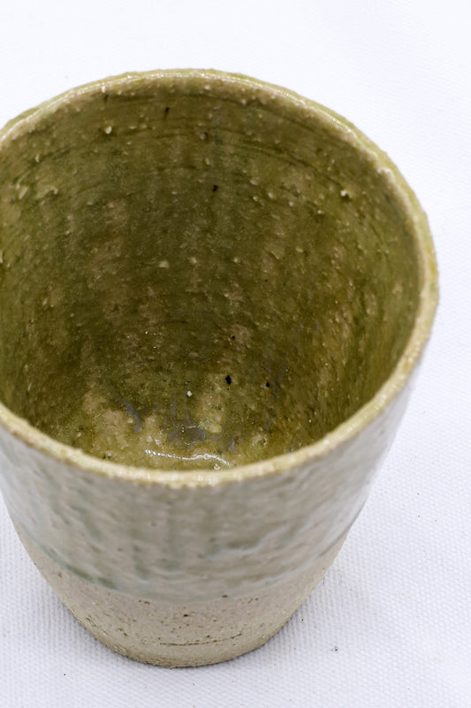 Beige Quadra Milled Stoneware tall ceramic cup by Ribera Handmade Ceramics, showcasing its textured handmade design.