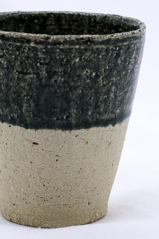Tall handmade ceramic cup from Ribera Handmade Ceramics, Blunero Quadra Milled Stoneware with a textured finish and classic design.
