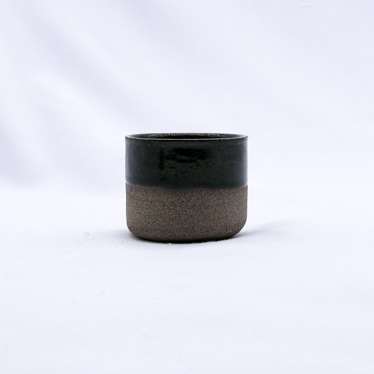 Green Picollo Smoked Grey handmade ceramic espresso mug by Ribera Handmade Ceramics, showcasing its textured stoneware surface.
