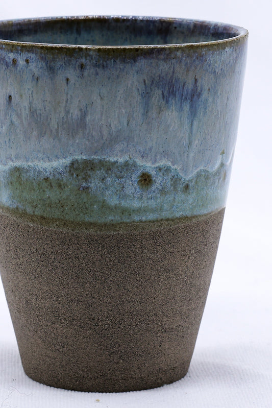 Handmade Ribera Ceramics Bluvio Quadra tall ceramic cup with smoked grey stoneware finish, showcasing its textured surface and elegant shape.
