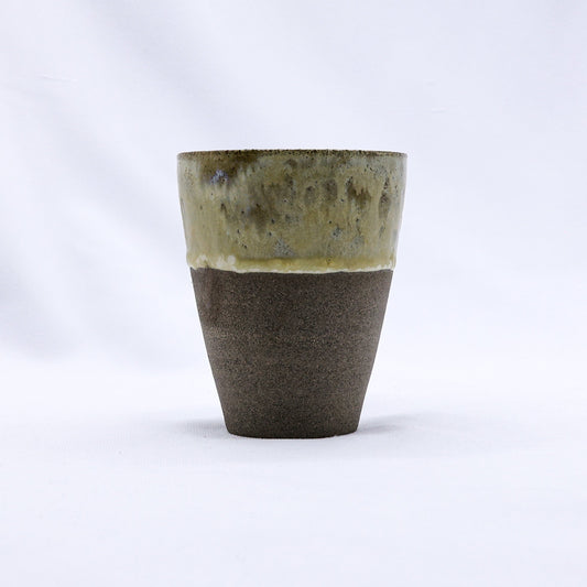 Tall TerraBlu Quadra ceramic cup by Ribera Handmade Ceramics with smoked grey stoneware finish, showcasing its handcrafted design.