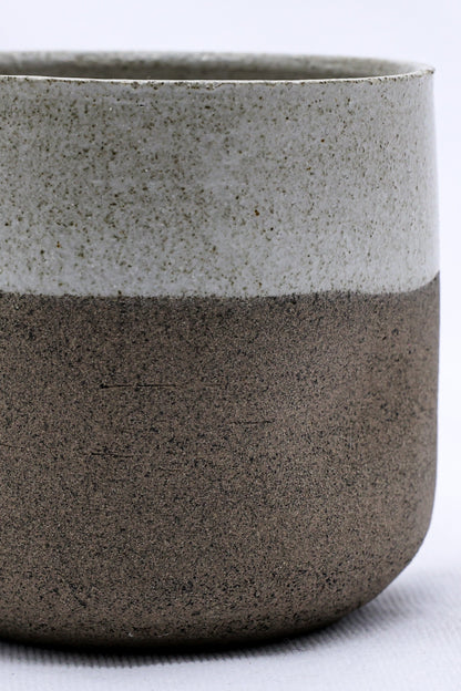 Handmade Bianca Goccio ceramic short cup in smoked grey stoneware by Ribera Handmade Ceramics, showcasing its textured surface and shape.