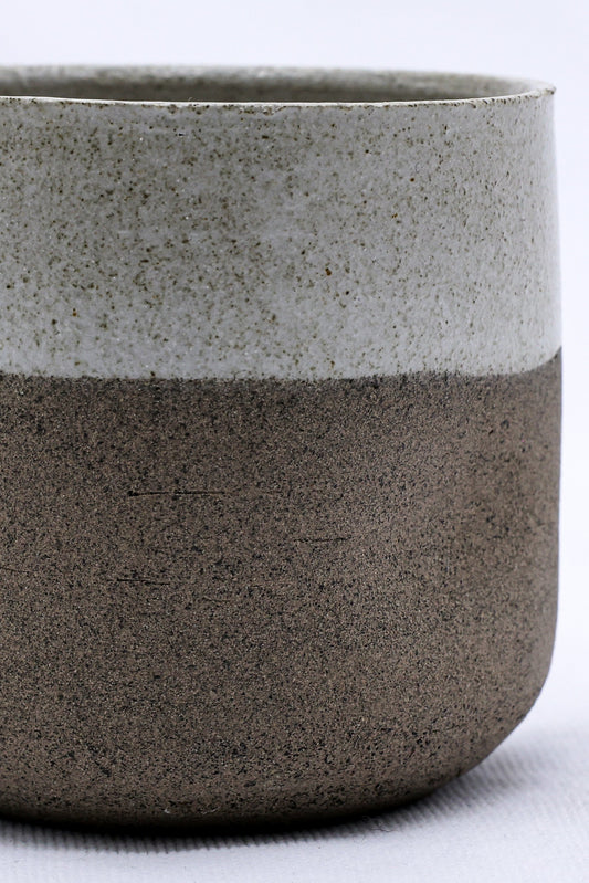 Handmade Bianca Goccio ceramic short cup in smoked grey stoneware by Ribera Handmade Ceramics, showcasing its textured surface and shape.