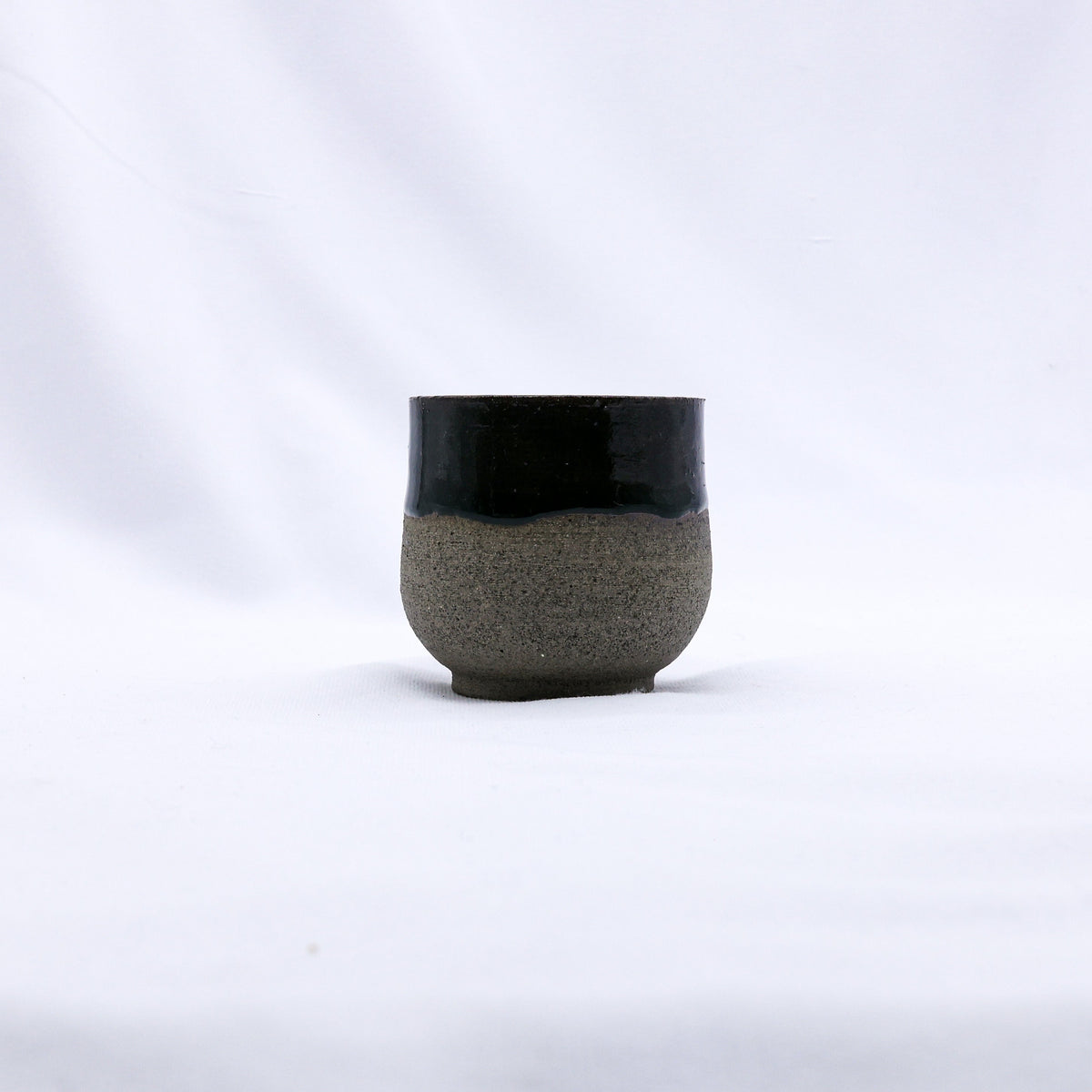 Handmade Bluverde smoked grey ceramic short cup by Ribera Handmade Ceramics with a smooth, rounded design.