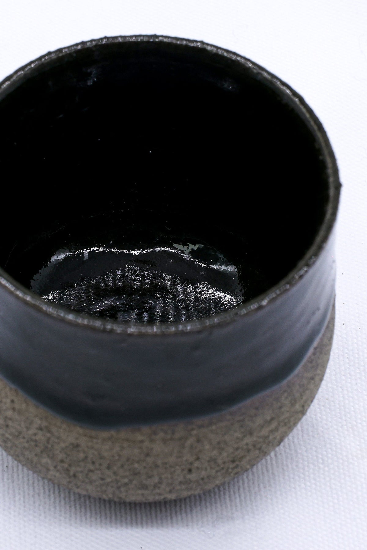 Handmade Bluverde smoked grey ceramic short cup by Ribera Handmade Ceramics, showcasing its textured stoneware surface.