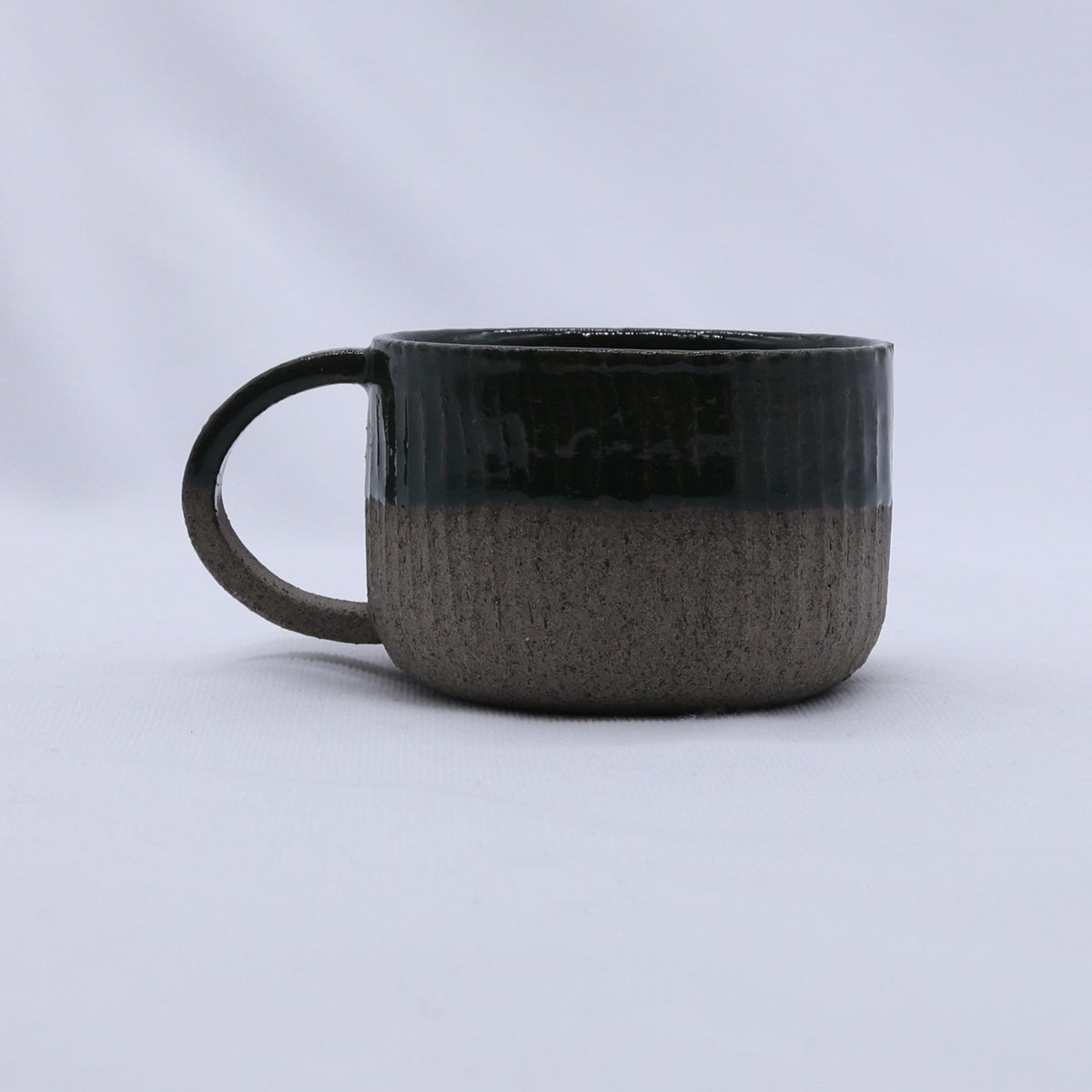 Handmade Bluverde Arte ceramic mug by Ribera Handmade Ceramics, smoked grey stoneware with a smooth, rounded handle.