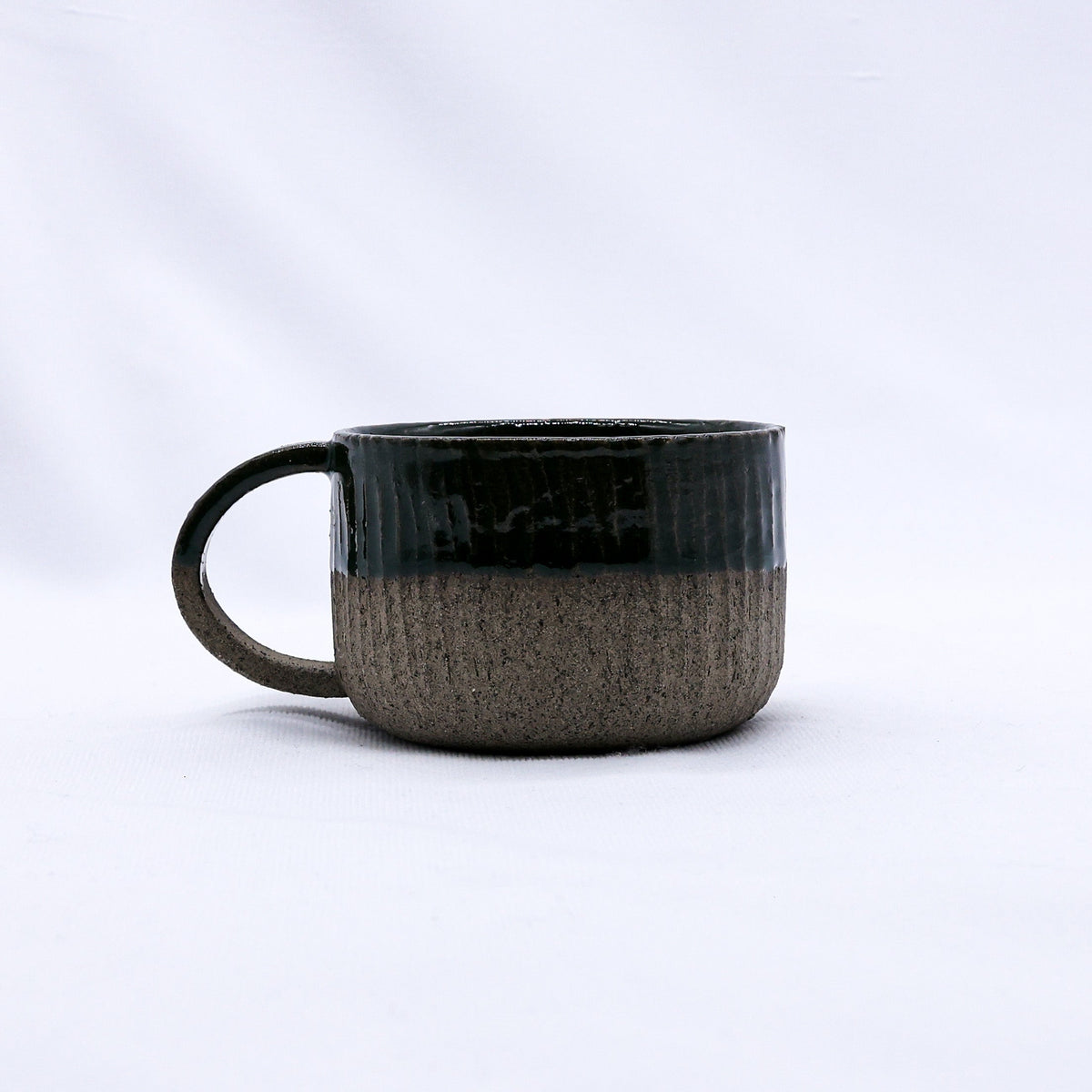 Handmade Bluverde Arte ceramic mug by Ribera Handmade Ceramics with smoked grey stoneware finish, featuring a smooth, rounded design.
