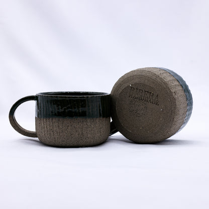 Handmade Bluverde Arte ceramic smoked grey stoneware mug by Ribera Handmade Ceramics, showcasing a rustic, textured surface.