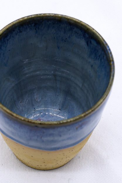 Ribera Handmade Ceramics Blunero Quadra stoneware ceramic mug with geometric design, white and blue glaze, on a wooden surface.