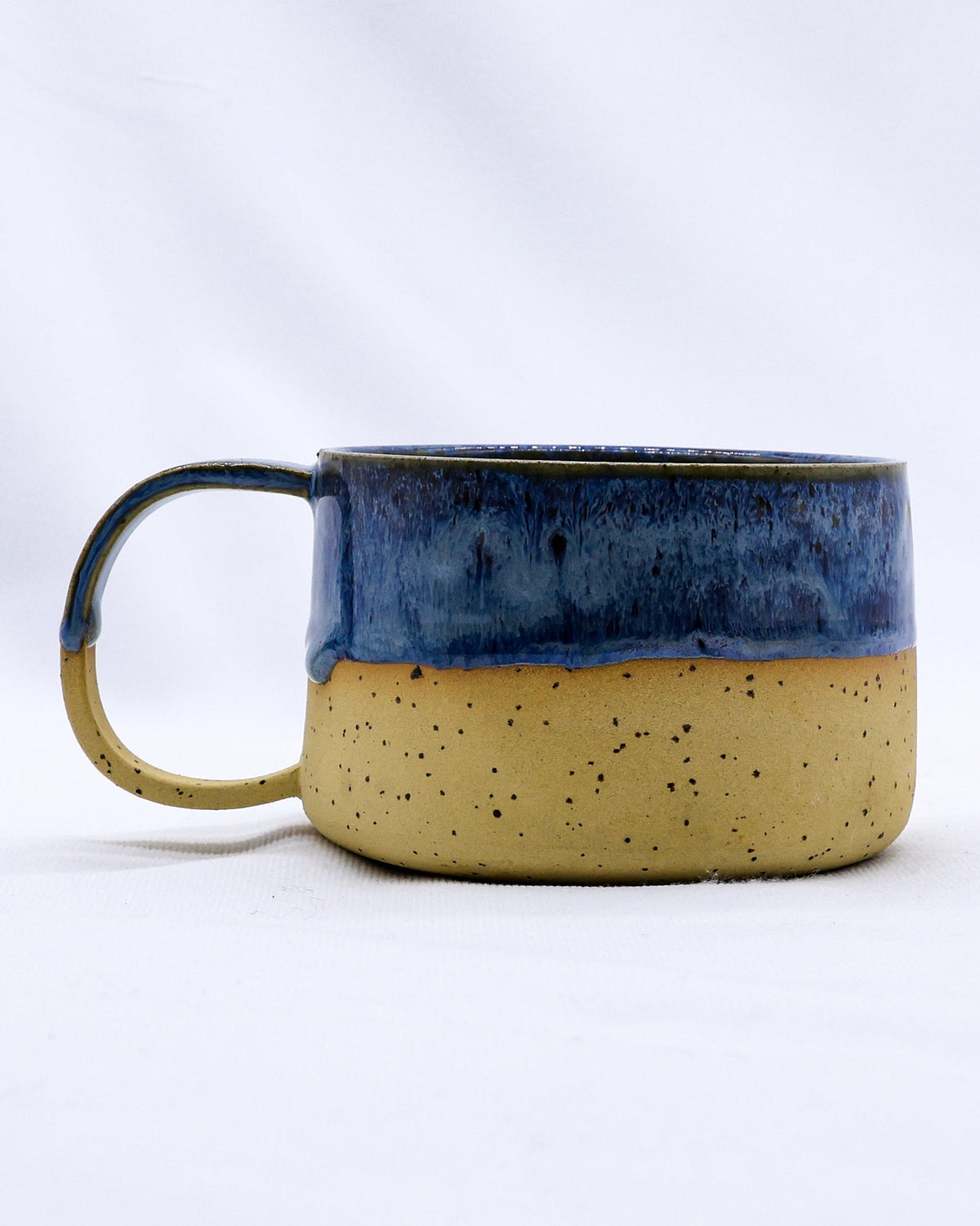Handmade stoneware ceramic mug from Ribera Handmade Ceramics, with a rustic glazed finish and sturdy handle.