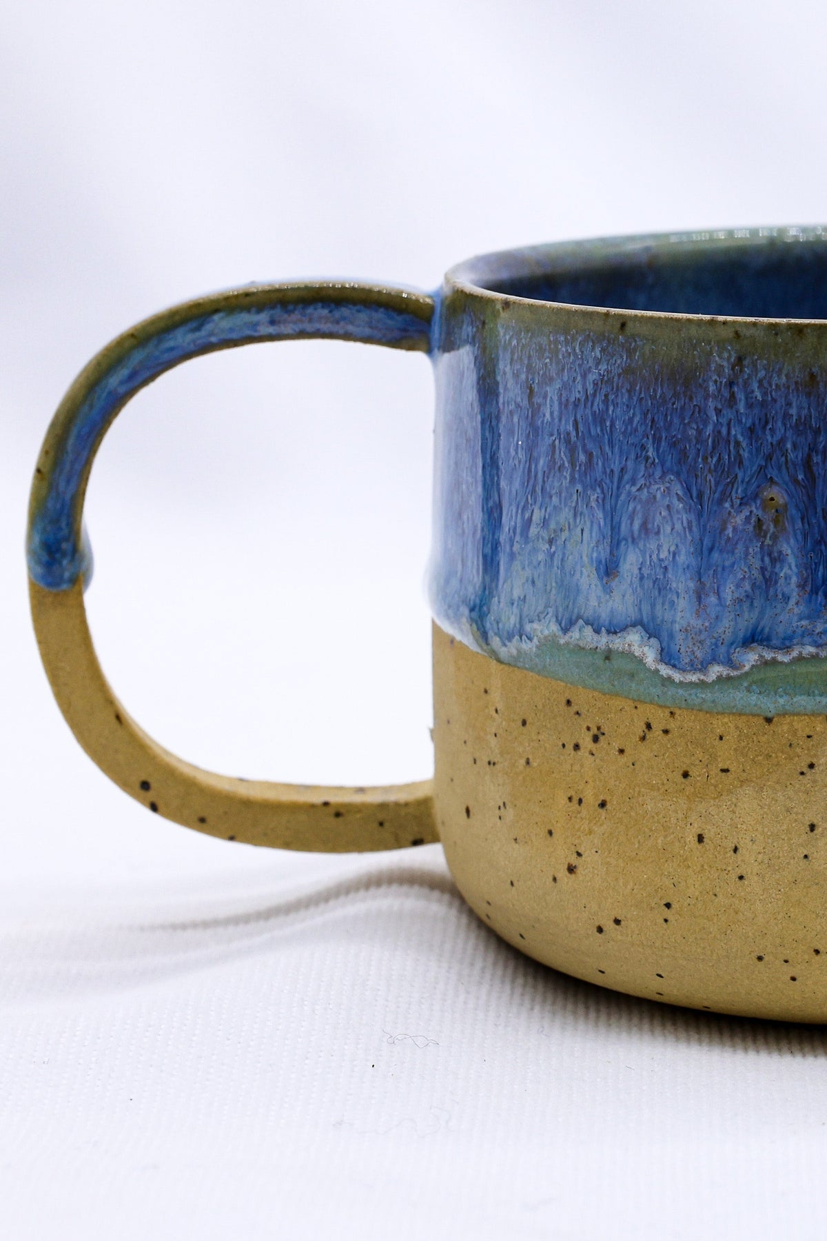 Handmade Bluverde Grande stoneware ceramic mug by Ribera Handmade Ceramics, showing its textured blue glaze and sturdy handle.