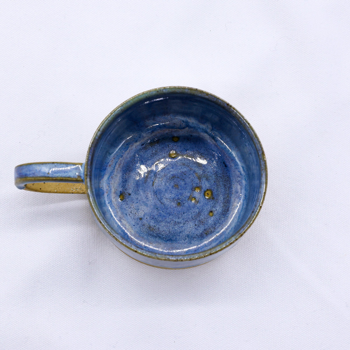 Large handmade stoneware ceramic mug by Ribera Handmade Ceramics with a rustic, textured finish and a sturdy handle.