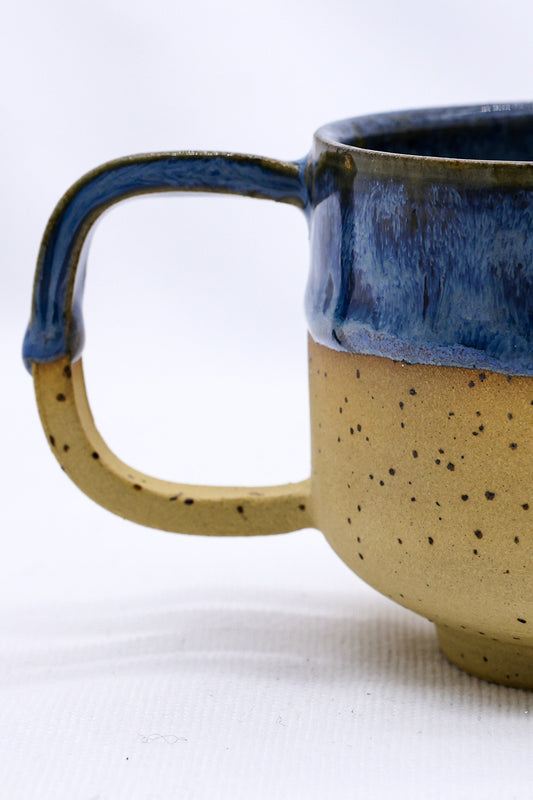 Bluverde Sienna handmade stoneware ceramic mug by Ribera Handmade Ceramics, featuring a textured blue and sienna glaze finish.