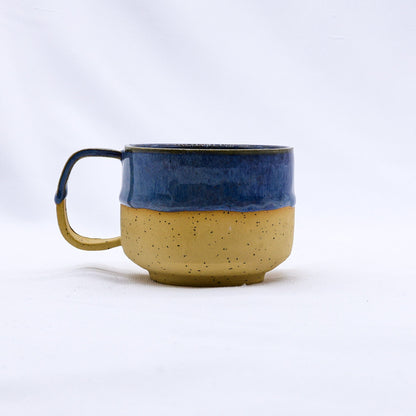 Ribera Handmade Ceramics Bluvio Sienna ceramic mug with a textured stoneware surface and a rounded handle on a plain background.