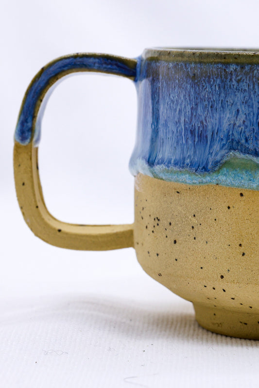 Handmade Sienna ceramic mug by Ribera Handmade Ceramics, featuring a textured glaze and rounded handle.