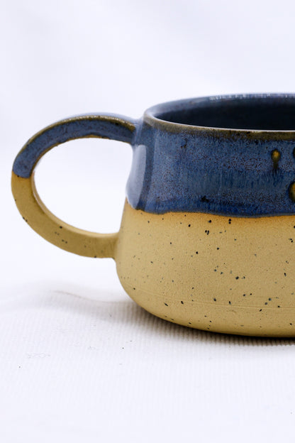 Ribera Handmade Ceramics Bluvio Belluma stoneware ceramic mug with a rustic, textured finish, featuring a sturdy handle and handcrafted details.