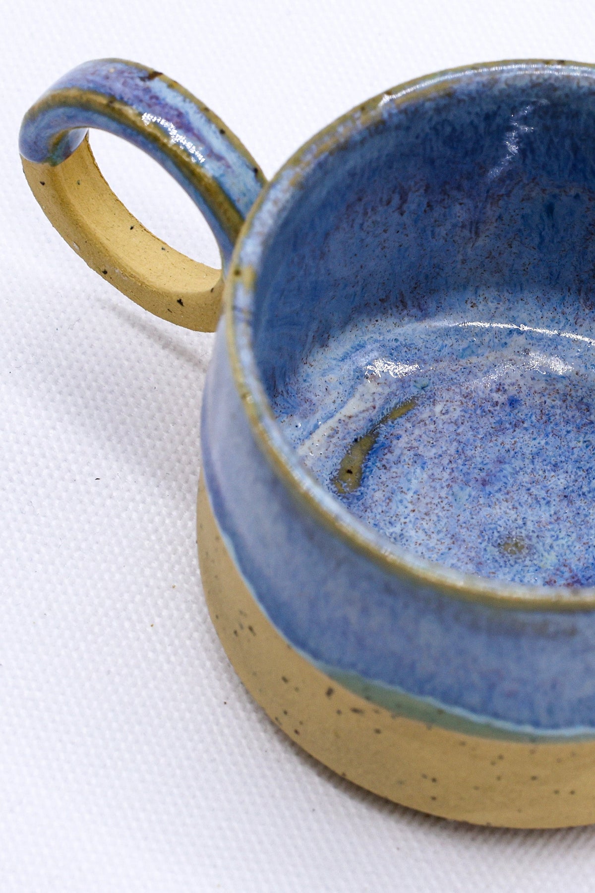 Handmade stoneware ceramic mug from Blulume Perugia by Ribera Handmade Ceramics, showcasing its textured ceramic surface and unique shape.