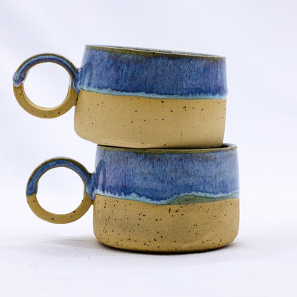 Handmade stoneware ceramic mug from Ribera Handmade Ceramics with a textured blue glaze and rustic finish.
