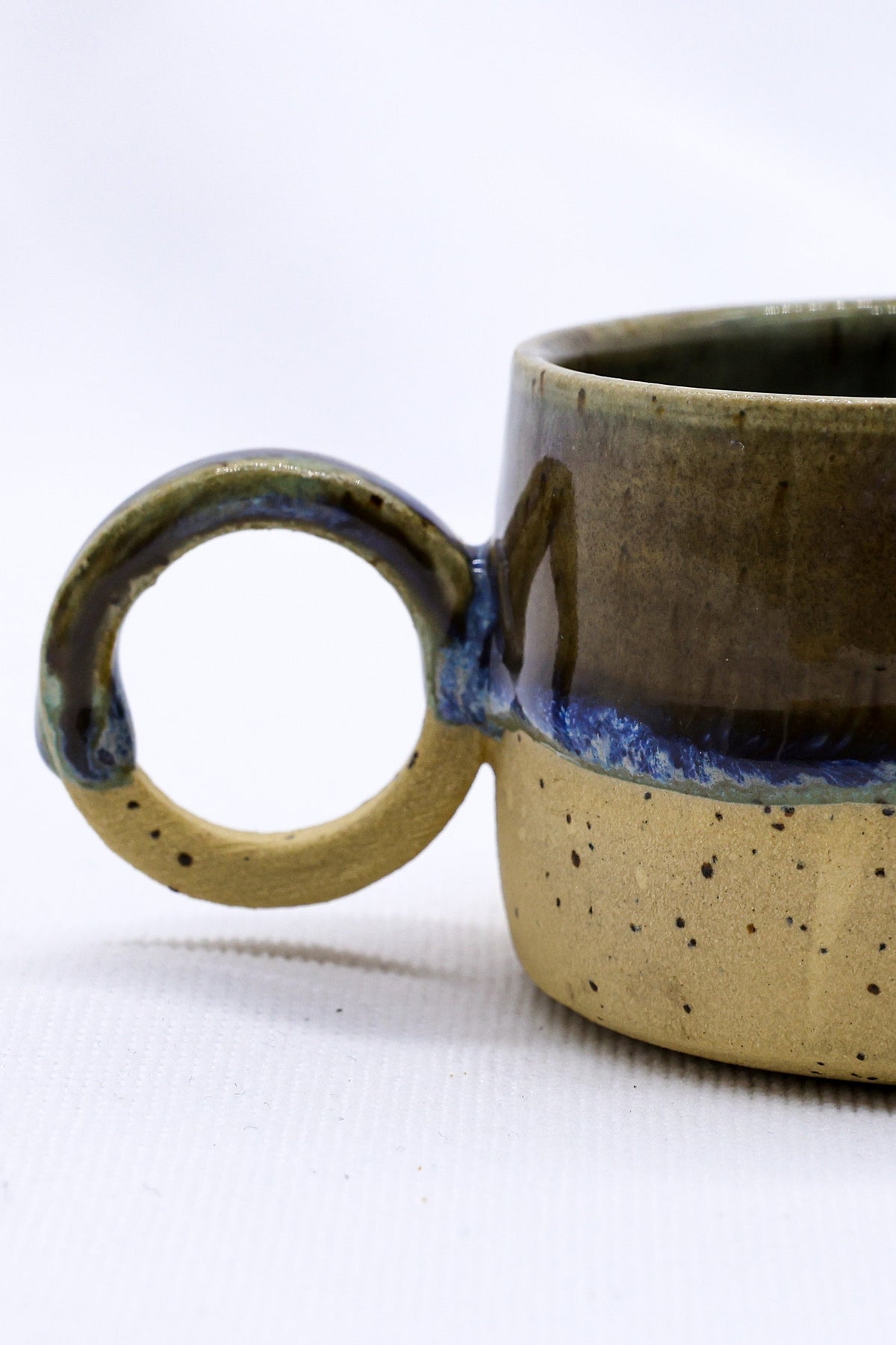 Bluvio Perugia handmade stoneware ceramic mug by Ribera Handmade Ceramics, featuring a textured, earthy finish and ergonomic handle.