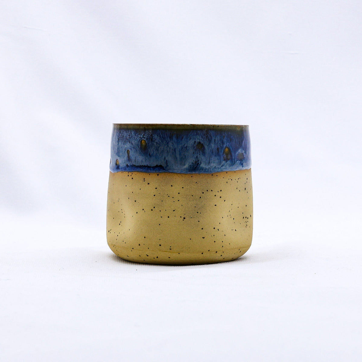 Handmade ceramic stoneware cup from Ribera Handmade Ceramics with a textured Goccia design, showcasing a unique artisanal finish.