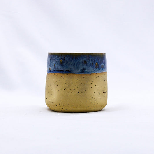 Handmade ceramic stoneware cup from Ribera Handmade Ceramics with a textured Goccia design, showcasing a unique artisanal finish.