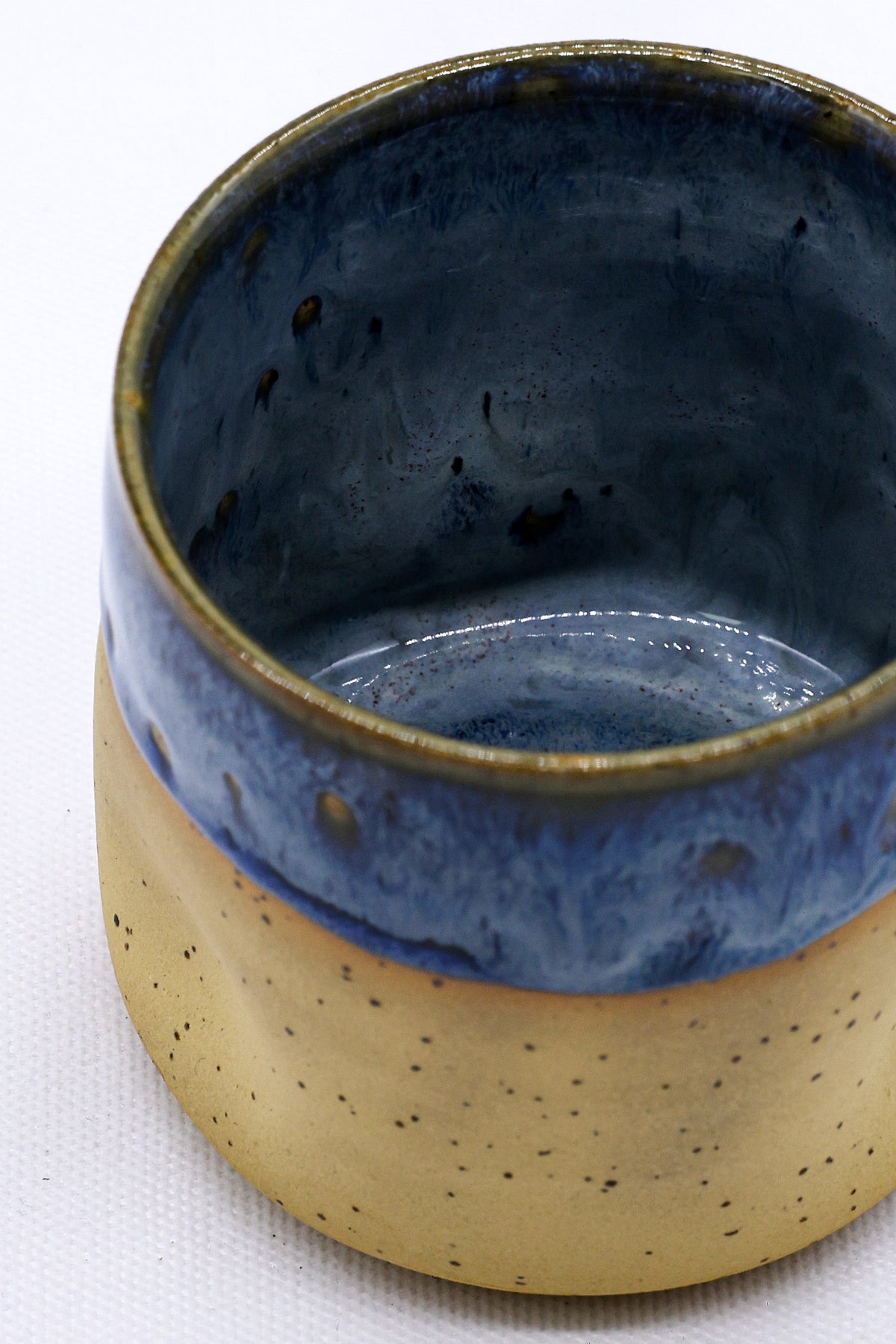 Handmade ceramic stoneware cup from Ribera Handmade Ceramics with a textured, Goccia design in blue glaze.