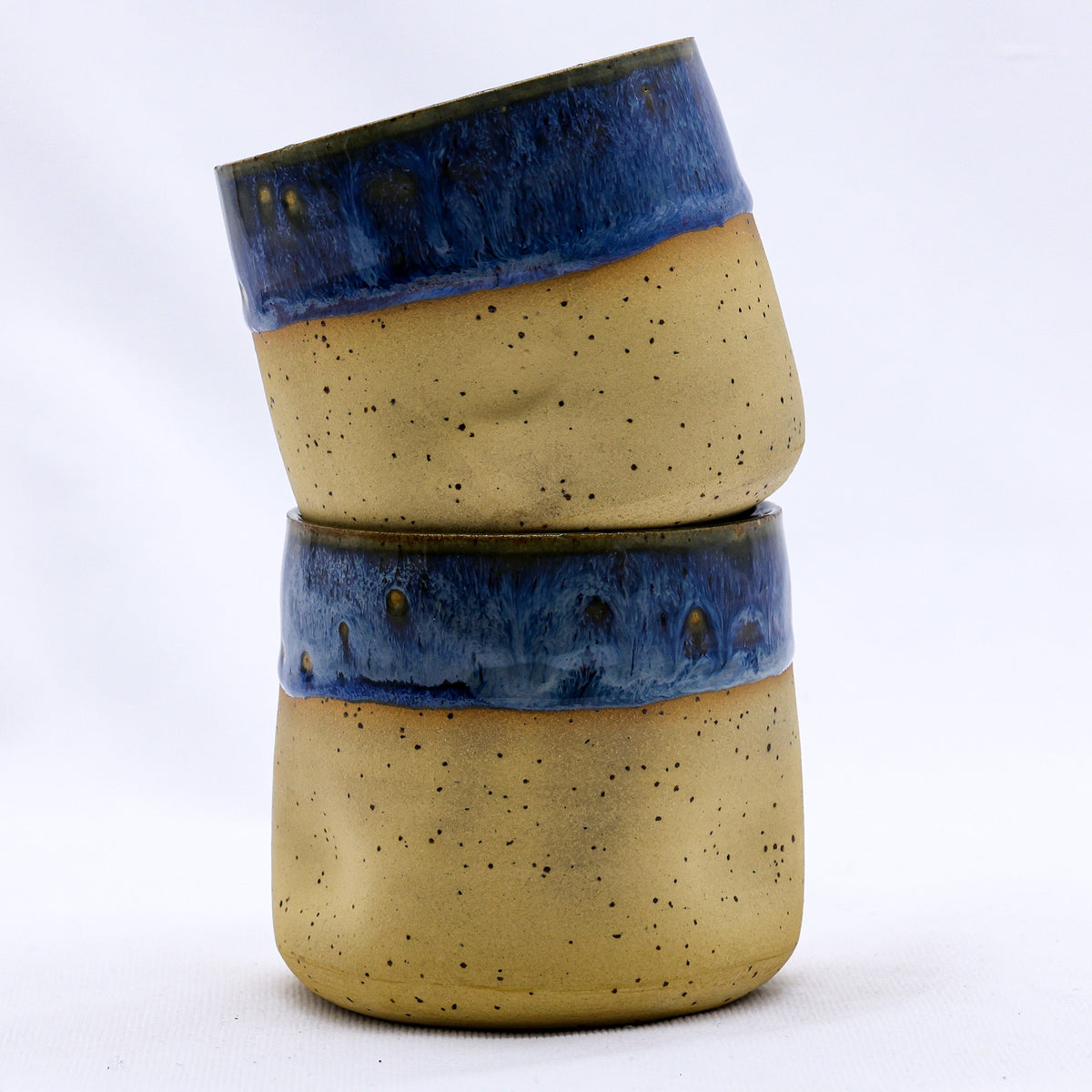 Handmade ceramic stoneware cup with a textured blue glaze from Ribera Handmade Ceramics, featuring a simple, elegant design.