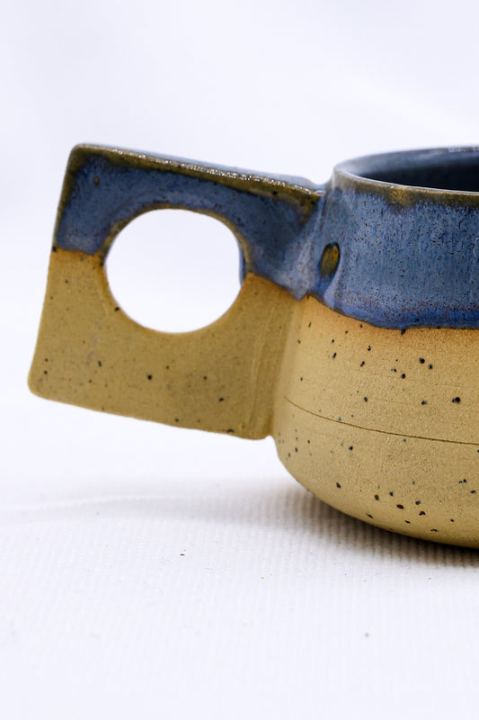 Handmade TerraBlu Formo ceramic stoneware coffee mug by Ribera Handmade Ceramics, featuring a textured blue glaze and ergonomic handle.