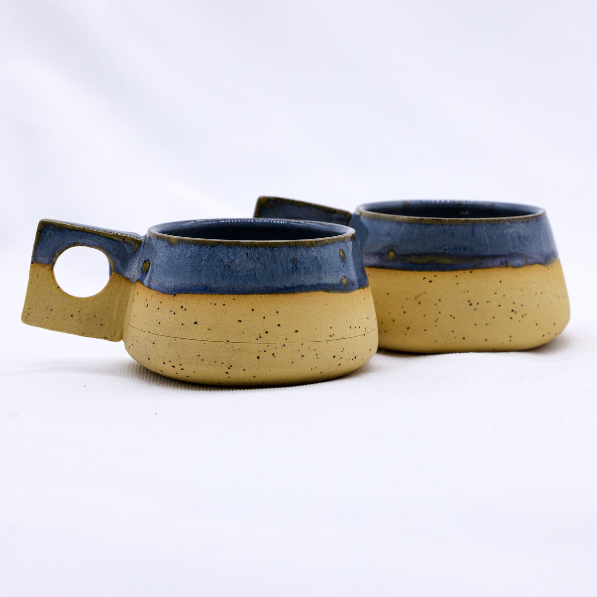 Handmade TerraBlu Formo ceramic stoneware coffee mug by Ribera Handmade Ceramics, showcasing a textured, artisanal finish.