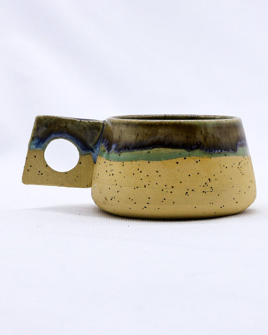 Handmade ceramic coffee mug from Ribera Handmade Ceramics with a textured stoneware finish and unique glazed design.