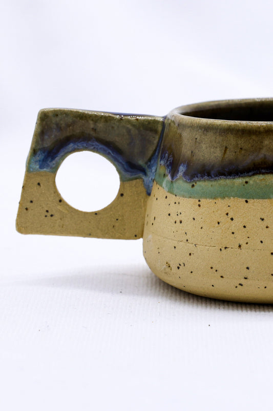 Handmade ceramic coffee mug with a textured stoneware finish from Ribera Handmade Ceramics, perfect for hot beverages.