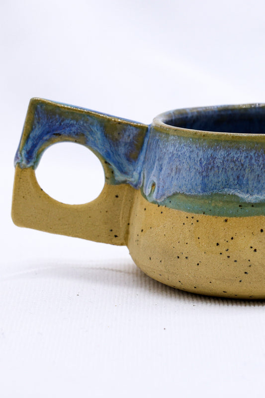 Ribera Handmade Ceramics Bluverde Formo ceramic coffee mug with a rustic, textured stoneware finish and a curved handle.