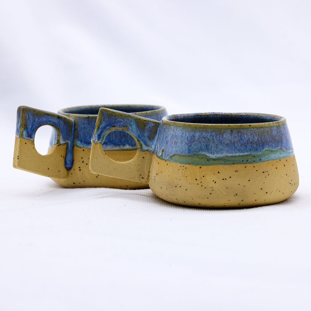 Bluverde Formo handmade ceramic stoneware coffee mug by Ribera Handmade Ceramics, showcasing a textured blue and earthy-toned finish.